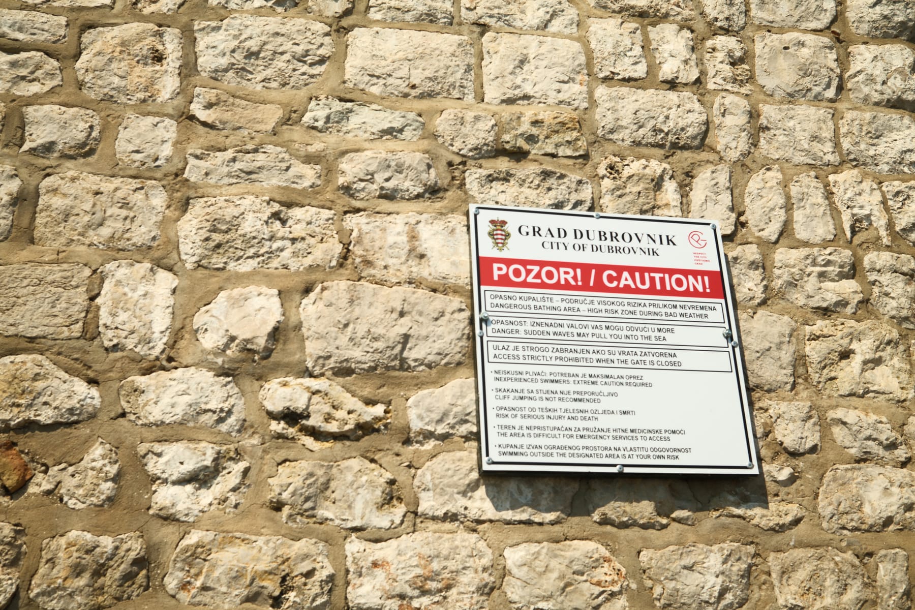 City of Dubrovnik caution sign: cliff jumping is not recommended, risk of serious injury and death